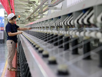 A worker is working on a textile production line in Fuzhou, China, on July 17, 2024. (