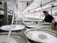 A worker is working on a textile production line in Fuzhou, China, on July 17, 2024. (