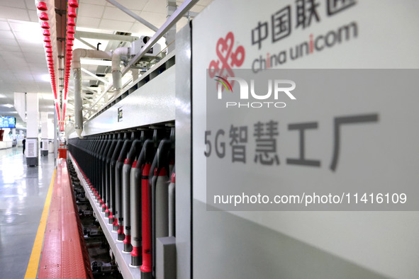 Spinning equipment is working automatically at a 5G smart factory in Fuzhou, China, on July 17, 2024. 