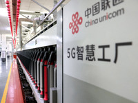 Spinning equipment is working automatically at a 5G smart factory in Fuzhou, China, on July 17, 2024. (