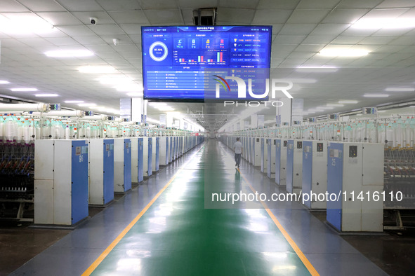 Spinning equipment is working automatically at a 5G smart factory in Fuzhou, China, on July 17, 2024. 