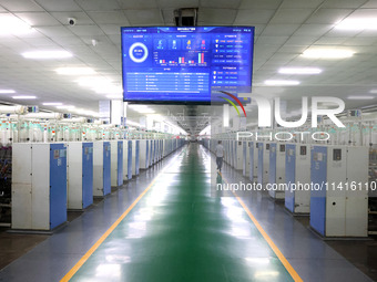 Spinning equipment is working automatically at a 5G smart factory in Fuzhou, China, on July 17, 2024. (