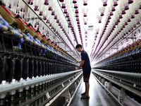 A worker is working on a textile production line in Fuzhou, China, on July 17, 2024. (