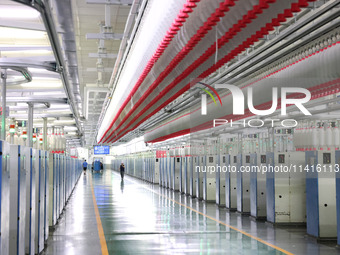 Spinning equipment is working automatically at a 5G smart factory in Fuzhou, China, on July 17, 2024. (