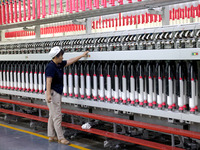 A worker is working on a textile production line in Fuzhou, China, on July 17, 2024. (