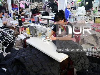 Workers are producing cotton clothing at a workshop in Liaocheng, China, on July 17, 2024. (