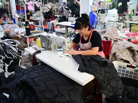 Workers are producing cotton clothing at a workshop in Liaocheng, China, on July 17, 2024. (