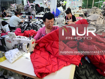 Workers are producing cotton clothing at a workshop in Liaocheng, China, on July 17, 2024. (