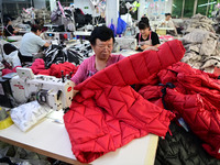 Workers are producing cotton clothing at a workshop in Liaocheng, China, on July 17, 2024. (