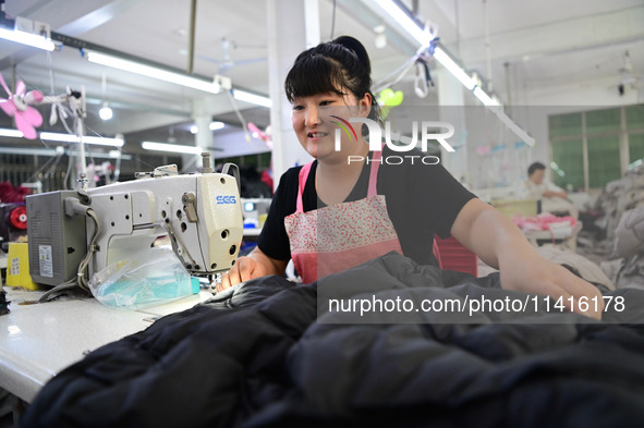 Workers are producing cotton clothing at a workshop in Liaocheng, China, on July 17, 2024. 