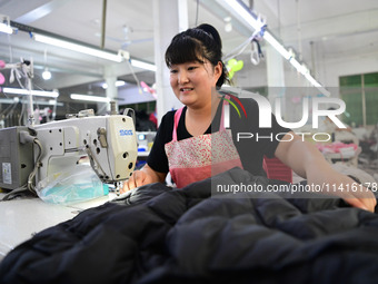 Workers are producing cotton clothing at a workshop in Liaocheng, China, on July 17, 2024. (