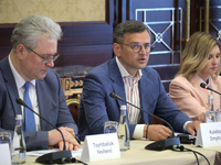 Ukrainian diplomat Yevhen Tsymbaliuk, Minister of Foreign Affairs of Ukraine Dmytro Kuleba, and First Lady Olena Zelenska (L to R) are atten...