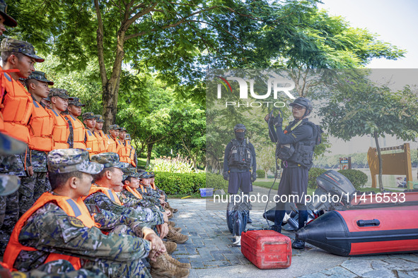 Armed police are training for flood control and rescue in Baise, China, on July 12, 2024. 