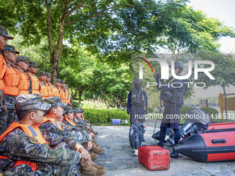 Armed police are training for flood control and rescue in Baise, China, on July 12, 2024. (