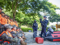 Armed police are training for flood control and rescue in Baise, China, on July 12, 2024. (