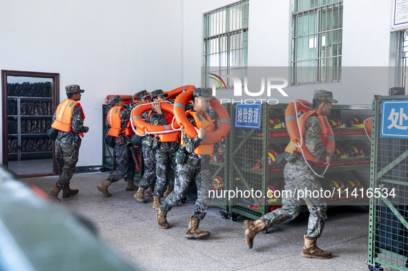 Armed police are training for flood control and rescue in Baise, China, on July 12, 2024. 