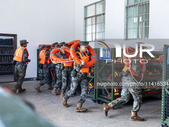 Armed police are training for flood control and rescue in Baise, China, on July 12, 2024. (