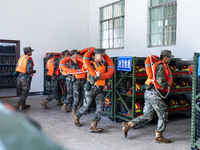 Armed police are training for flood control and rescue in Baise, China, on July 12, 2024. (