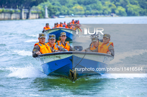 Armed police are training for flood control and rescue in Baise, China, on July 12, 2024. 