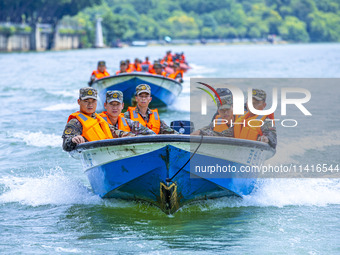 Armed police are training for flood control and rescue in Baise, China, on July 12, 2024. (