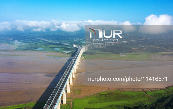 A photo is showing the sunny scenery of the Sanmenxia section of the Yellow River in Sanmenxia, China, on July 18, 2024. 