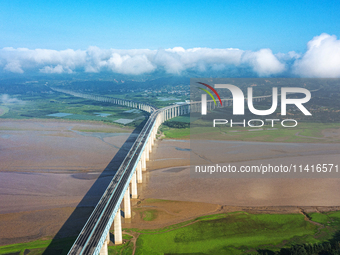 A photo is showing the sunny scenery of the Sanmenxia section of the Yellow River in Sanmenxia, China, on July 18, 2024. (