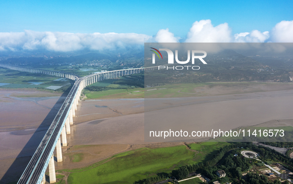 A photo is showing the sunny scenery of the Sanmenxia section of the Yellow River in Sanmenxia, China, on July 18, 2024. 