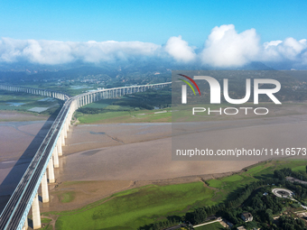 A photo is showing the sunny scenery of the Sanmenxia section of the Yellow River in Sanmenxia, China, on July 18, 2024. (