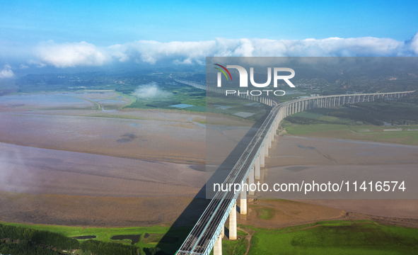 A photo is showing the sunny scenery of the Sanmenxia section of the Yellow River in Sanmenxia, China, on July 18, 2024. 