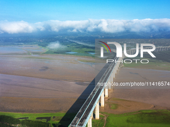 A photo is showing the sunny scenery of the Sanmenxia section of the Yellow River in Sanmenxia, China, on July 18, 2024. (