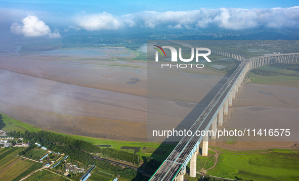 A photo is showing the sunny scenery of the Sanmenxia section of the Yellow River in Sanmenxia, China, on July 18, 2024. 