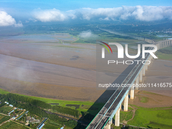 A photo is showing the sunny scenery of the Sanmenxia section of the Yellow River in Sanmenxia, China, on July 18, 2024. (