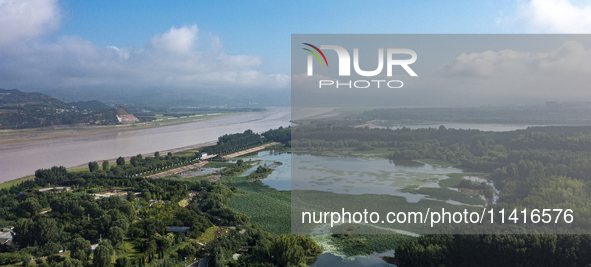 A photo is showing the sunny scenery of the Sanmenxia section of the Yellow River in Sanmenxia, China, on July 18, 2024. 