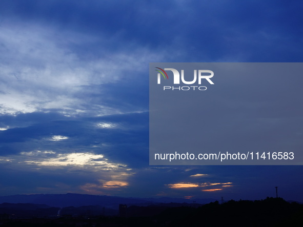 Black clouds are covering the sky at sunrise in Yichang, China, on July 18, 2024. 