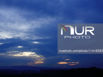 Black clouds are covering the sky at sunrise in Yichang, China, on July 18, 2024. (