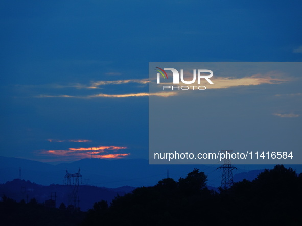 Black clouds are covering the sky at sunrise in Yichang, China, on July 18, 2024. 