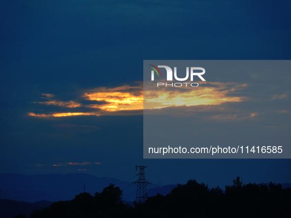 Black clouds are covering the sky at sunrise in Yichang, China, on July 18, 2024. 