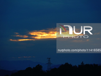 Black clouds are covering the sky at sunrise in Yichang, China, on July 18, 2024. (