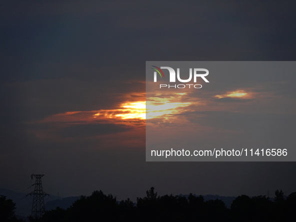 Black clouds are covering the sky at sunrise in Yichang, China, on July 18, 2024. 