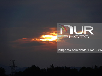 Black clouds are covering the sky at sunrise in Yichang, China, on July 18, 2024. (