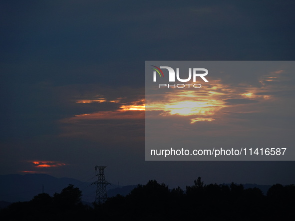 Black clouds are covering the sky at sunrise in Yichang, China, on July 18, 2024. 