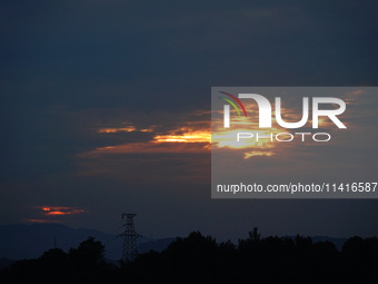 Black clouds are covering the sky at sunrise in Yichang, China, on July 18, 2024. (