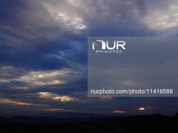 Black clouds are covering the sky at sunrise in Yichang, China, on July 18, 2024. 