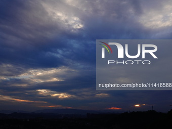 Black clouds are covering the sky at sunrise in Yichang, China, on July 18, 2024. (