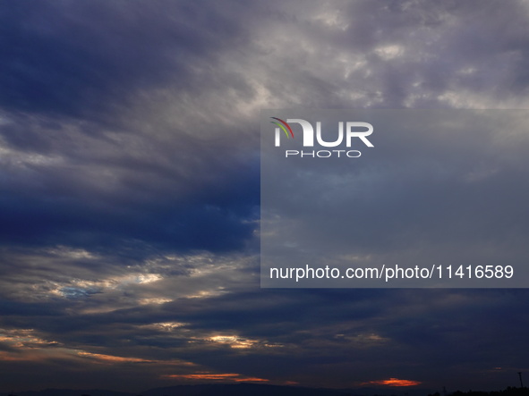 Black clouds are covering the sky at sunrise in Yichang, China, on July 18, 2024. 