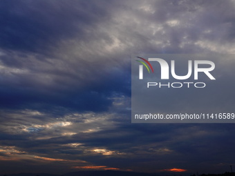 Black clouds are covering the sky at sunrise in Yichang, China, on July 18, 2024. (