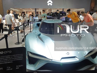 Visitors are viewing the NIO EP9 electric supercar at the 21st Changchun International Automobile Expo in Changchun, Jilin province, China,...