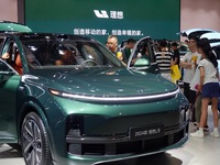 Visitors are looking at the 2024 Li Auto L9 electric car at the 21st Changchun International Automobile Expo in Changchun, Jilin province, C...