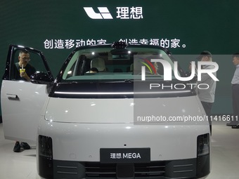 Visitors are looking at the 2024 Li Auto MEGA electric car at the 21st Changchun International Automobile Expo in Changchun, China, on July...