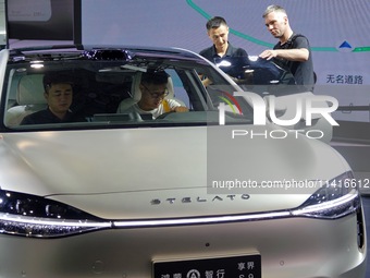 Spectators are looking at the Harmony OS Stelato S9 electric car at the 21st Changchun International Automobile Expo in Changchun, China, on...